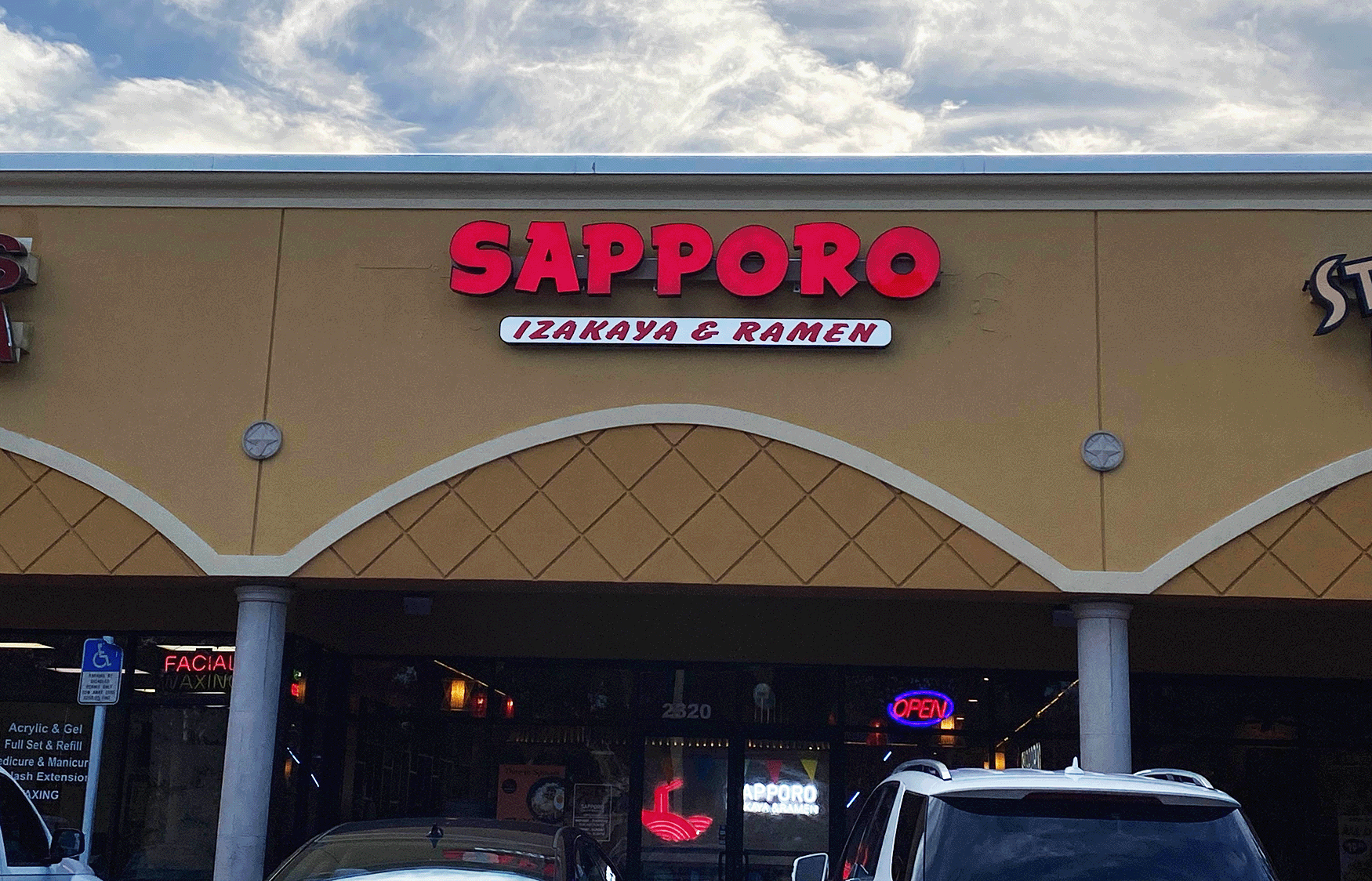 front of sapporo ramen building with red letter sign